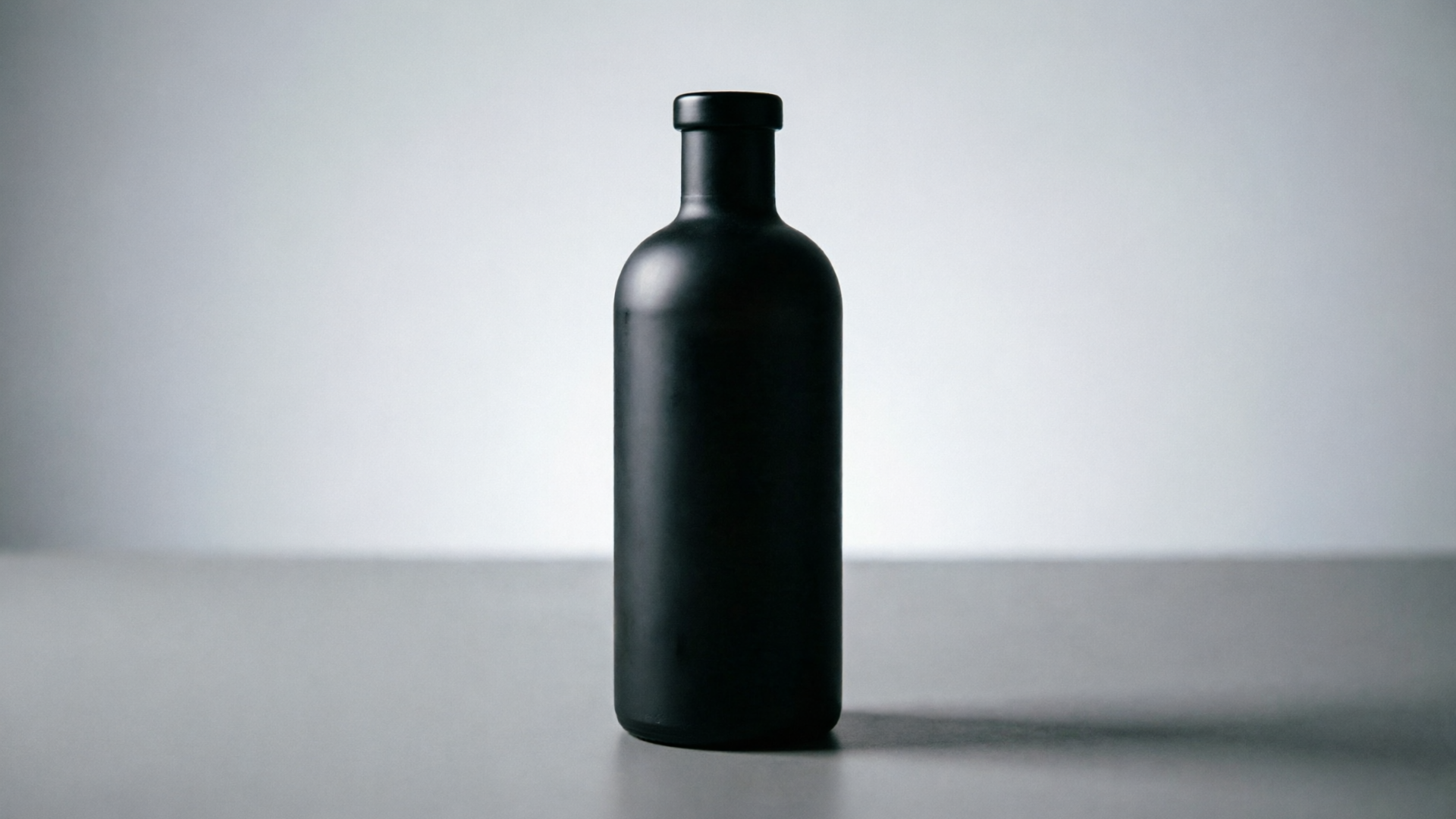 Matte black bottle on table for parallax animation
