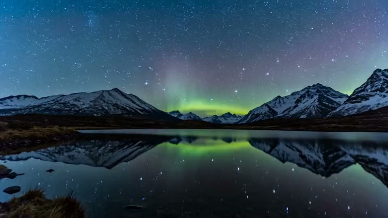 AI-generated video still from the prompt “aurora over a mountain lake”