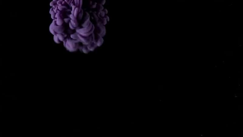 AI-generated video still from the prompt “ink blooming in water”